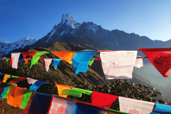 Yoga_In_Himalayas Tibetan flags and a view of the Himalayas