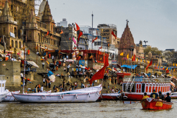 Vibrant colored boats and flags along the banks of river Ganga